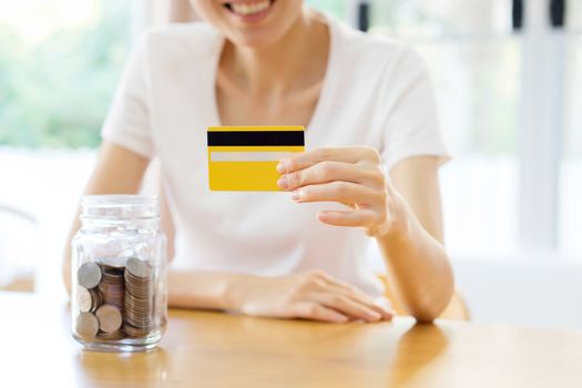 woman showing blank credit card. Focus on card. And savings