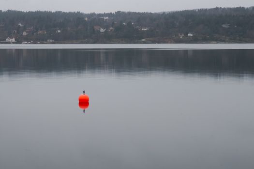 Reflection of buoy along the shores of the bay of Oslo