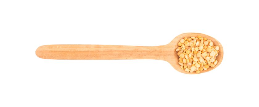 Dried peas in a wooden spoon on a white background