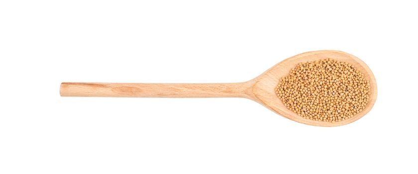 Mustard seeds in wooden scoop over white background