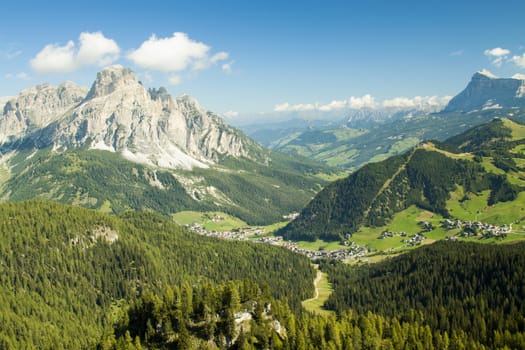 Green valley with the village of Corvara in the dolomities