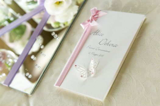 View of a partecipation by invitation with pink ribbon and paper butterfly