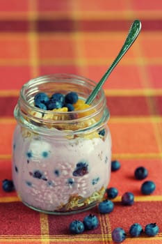 yogurt in a jar with blueberries and cereals, healthy breakfast