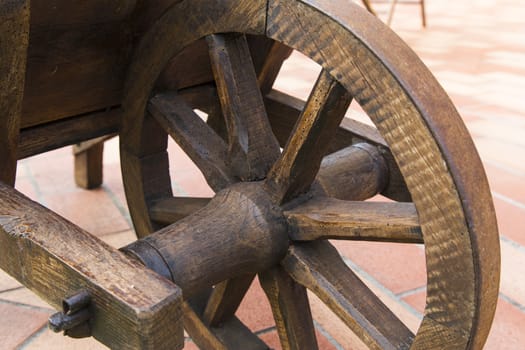 View of a wooden wheel of an ancient wheelbarrow