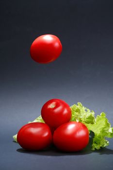 Cooking concept. Few freshness red tomatoes on dark background