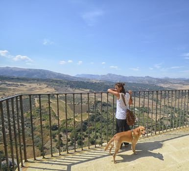 Woman and her dog at the terrace of Ronda 