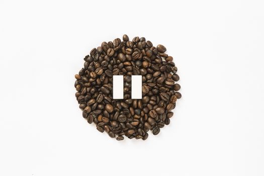 Concept of a coffee pause, coffee beans arranged in a circle with sugar cubes.