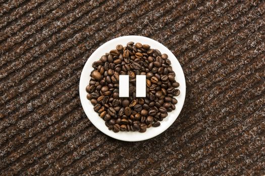 Concept of a coffee pause, coffee beans arranged in a circle with sugar cubes.