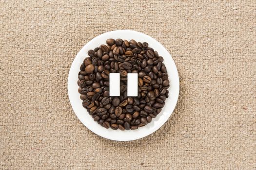 Concept of a coffee pause, coffee beans arranged in a circle with sugar cubes.