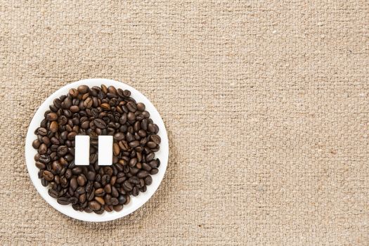 Concept of a coffee pause, coffee beans arranged in a circle with sugar cubes.