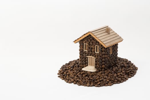 House made of coffee on white background