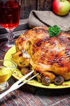 Chicken cooked in vegetables on vintage wooden surface