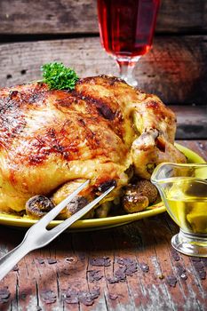 Chicken cooked in vegetables on vintage wooden surface