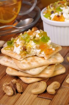 portion of cottage cheese with jam and marmalade, nuts on a cracker