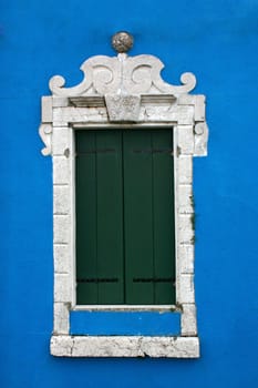 Window of one of the colored houses in Burano - Venice - Italy