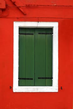 Window of one of the colored houses in Burano - Venice - Italy