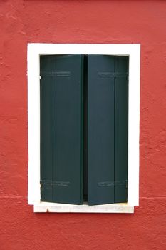 Window of one of the colored houses in Burano - Venice - Italy