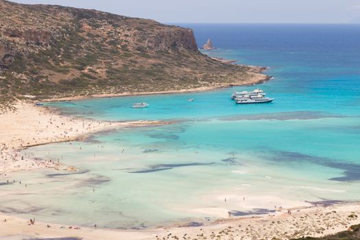 Breathtaking panorama of Balos beach and lagoon and Gramvousa island on Crete, Greece. Tourist boats mooring in lagoon.