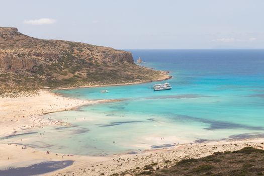 Breathtaking panorama of Balos beach and lagoon and Gramvousa island on Crete, Greece. Tourist boats mooring in lagoon.
