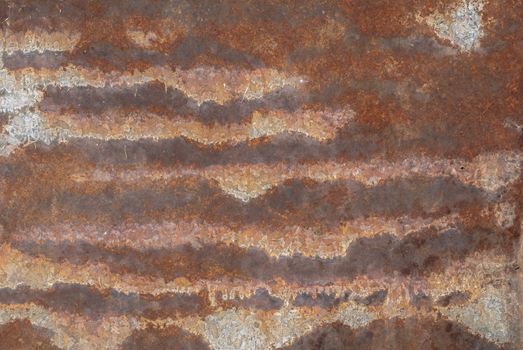 rusty iron surface covered with old chipped grey color paint, which has long been influenced by different climatic conditions