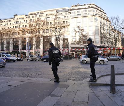 FRANCE, Paris : Police patrol the streets ahead of New Year's celebrations on the Champs-Elysees avenue in Paris on December 31, 2015. 