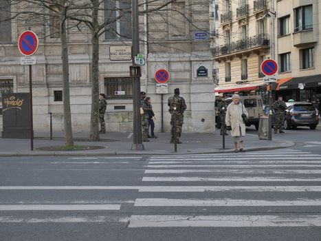 FRANCE, Paris : Army patrol the streets ahead of New Year's celebrations on the Champs-Elysees avenue in Paris on December 31, 2015. 