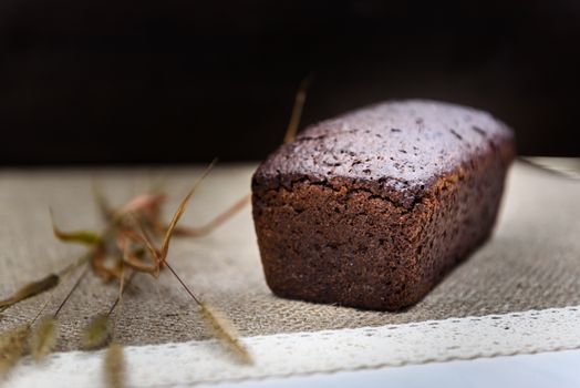 black bread on burlap with ears on a white board