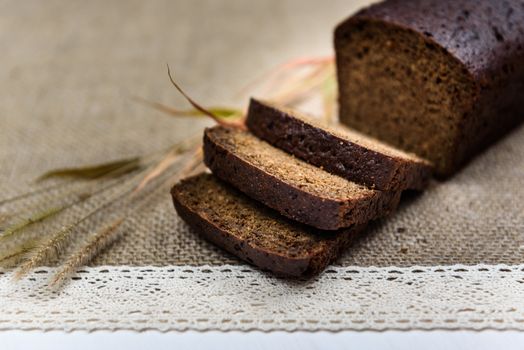 black bread on burlap with ears on a white board