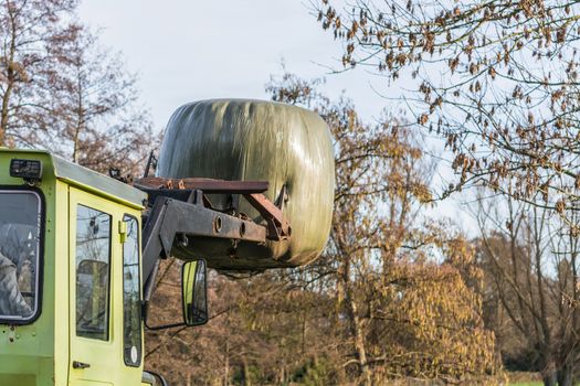 View details bale of hay transport with an old farm machine.