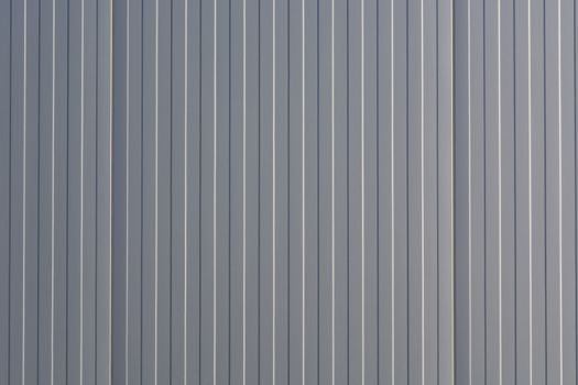 Silver-colored metal wall corrugated sheet metal background.