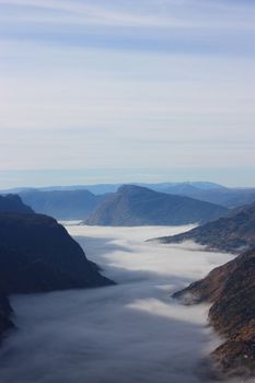 The mountain Molden rais above Lustrafjorden coverd in fog.