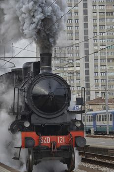 View of steam locomotive leaving the station of Rimini