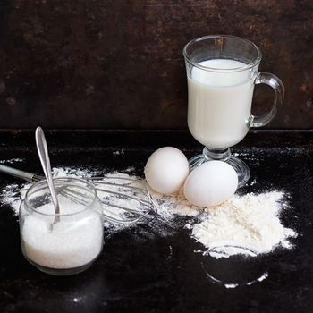 Ingredients for a cake on a black natural stone