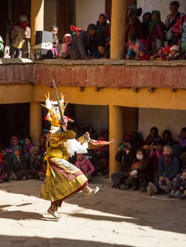 Korzok,India - July 23, 2012: unidentified monk in deer mask with sword performs religious mystery dance of Tibetan Buddhism during the Cham Dance Festival in Korzok monastery, India.