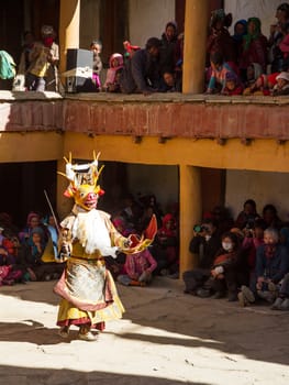 Korzok,India - July 23, 2012: unidentified monk in deer mask with sword performs religious mystery dance of Tibetan Buddhism during the Cham Dance Festival in Korzok monastery, India.