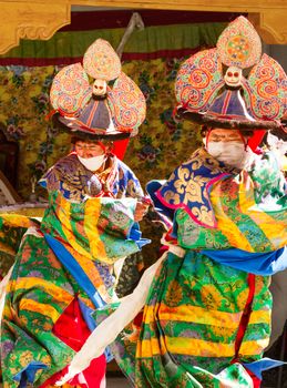 Kursha, India - July 17, 2012: Two lamas performs a religious masked and costumed mystery black hat dance of Tibetan Buddhism during the Cham Dance Festival in Kursha monastery, India.