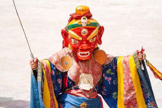Unidentified monk with sword performs a religious masked and costumed mystery dance of Tibetan Buddhism during the Cham Dance Festival in Hemis monastery, India.