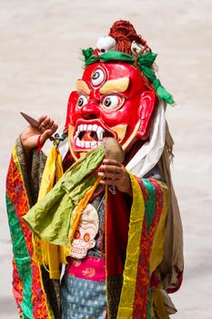 Unidentified monk with phurpa (ritual knife) performs a religious masked and costumed mystery dance of Tibetan Buddhism during the Cham Dance Festival in Hemis monastery, India.