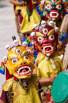 Unidentified monks with drums performs a religious masked and costumed mystery dance of Tibetan Buddhism during the Cham Dance Festival in Hemis monastery, India.
