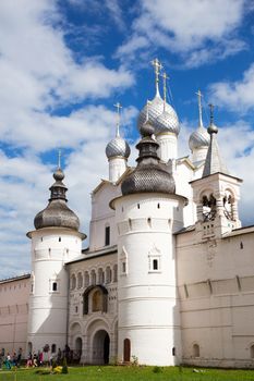 Rostov Veliky, Russia - Jun 12, 2015: Group of tourists near the Holy Gates and the Resurrection Church with belfry in the Kremlin of the Rostov Veliky (Rostov the Great, Golden Ring of Russia)  on a sunny day on Jun 12, Rostov Veliky, Russia.