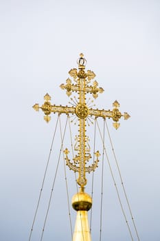 Gold cross of the central dome of the Cathedral of the Assumption of Blessed Virgin Mary at Holy Trinity St. Sergius (Sergiev Posad, Russia).