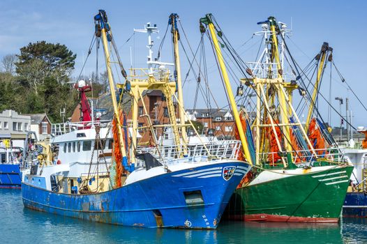 Rusty fishing trawlers moored in the port of a small fishing village