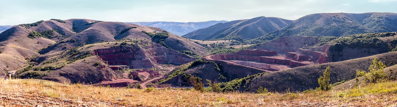 Opencast mining rare red marble. Panorama shooting.