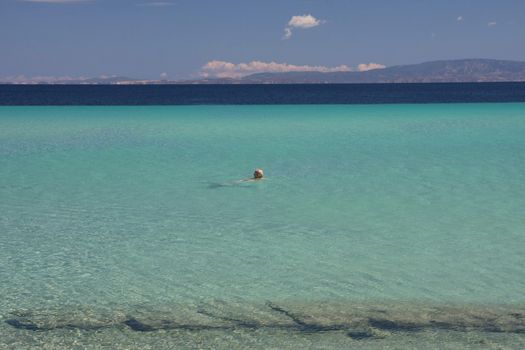 Woman enjoying swimming in sthe sea with fantastic colours