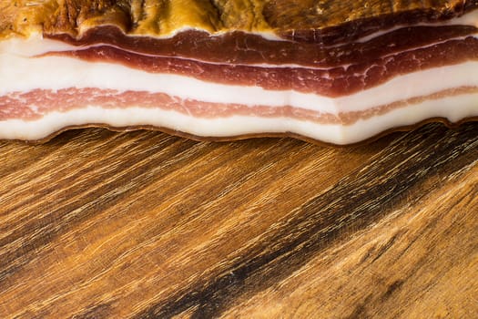 Smoked bacon on vintage wooden board