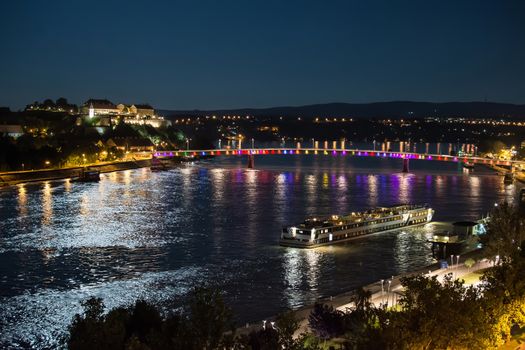 Petrovaradin fortress and "Rainbow bridge" over the Danube, between Novi Sad and Petrovaradin in the moonlight with ship docking