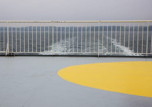 Ship Foam Trail from Ferry with Yellow Heliport Landing Marker and Railing