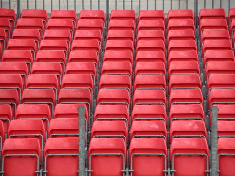 Closeup on Concert Spectator Steel Platform with Rows of Red Plastic Seats
