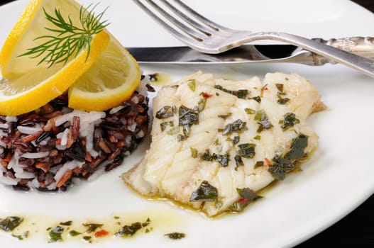 Slices of boiled fish with pesto and black, brown, white rice
