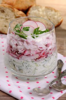 Salad of grated radish and cucumber with yogurt in a glass